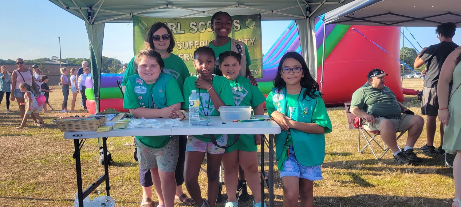 Laura Sorgie, coordinator for Service Unit 48 of the Girl Scouts of Suffolk County (back left), is with Girl Scouts Mackenzie Walsh (left), Iyana Jackson (center left), Olivia Phillips (back right), Milania Davis (center right), and Maya Avila Garay (right) at the Girl Scouts of Suffolk County tent.